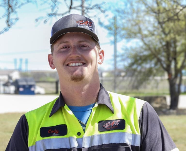Light duty team member Cody Vance operating wheel lift in Central Texas